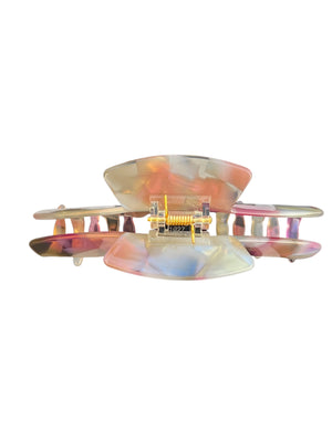 Top view of the Aura pastel blend hat claw clip showing the spring hinge and curved teeth for a secure hold.