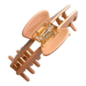 Bottom view of the Biscotti warm beige hat claw clip showing the hinge, teeth, and secure grip design.