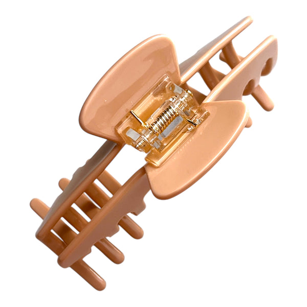 Bottom view of the Biscotti warm beige hat claw clip showing the hinge, teeth, and secure grip design.
