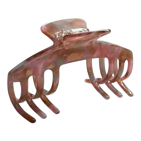 Angled view of the Blush pink hat claw clip showing its curved shape, soft pink finish, and secure grip.
