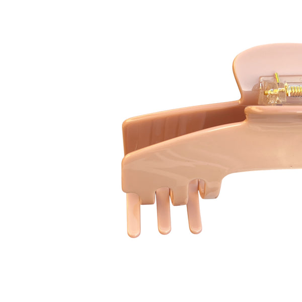 Close-up of the Cashmere blush nude hat claw clip highlighting the smooth finish, spring hinge, and curved grip teeth.