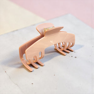 Cashmere blush nude hat claw clip displayed on a soft neutral surface, highlighting its polished finish and everyday style.