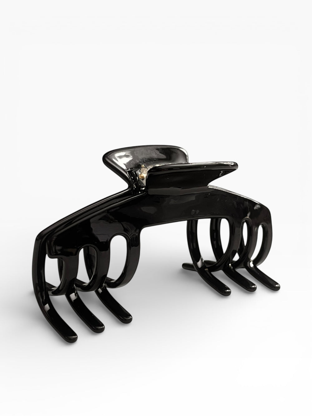 Front view of the Eclipse glossy black hat claw clip designed for secure, comfortable hairstyles while wearing hats.