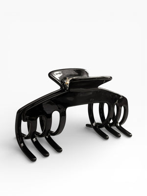 Angled view of the Eclipse glossy black hat claw clip showing its curved shape, sleek finish, and secure grip.
