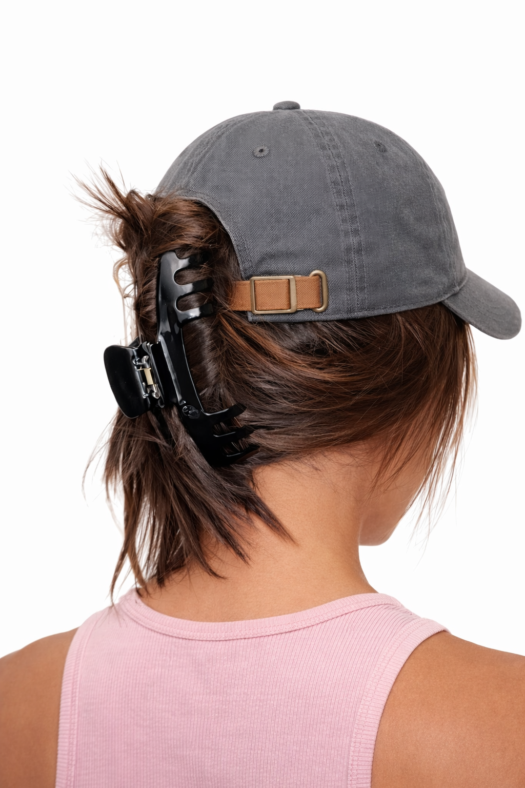 Person wearing a gray cap with an Eclipse Hat Claw Clip by Baddie Clip 