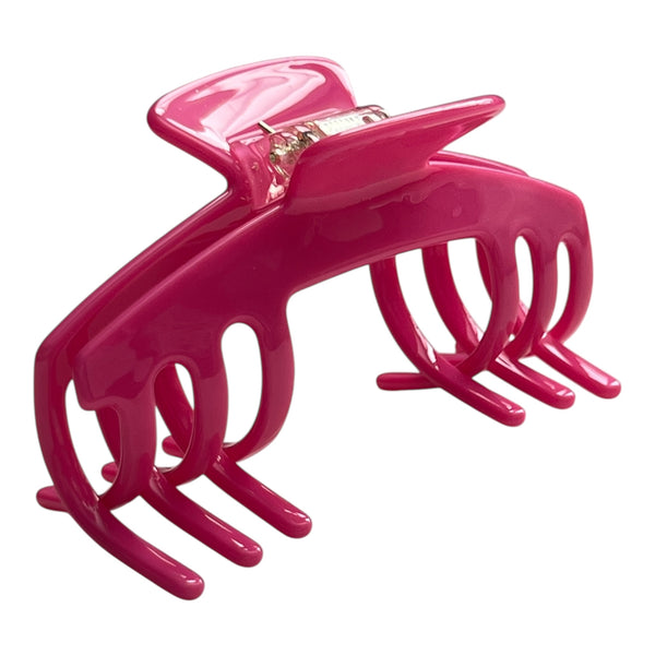 Angled view of the Flamingo hot pink hat claw clip showing its curved shape, bright finish, and secure grip.