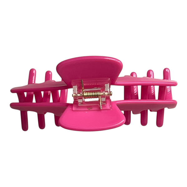 Back view of the Flamingo hot pink hat claw clip showing the spring hinge and wide opening for a secure hold.