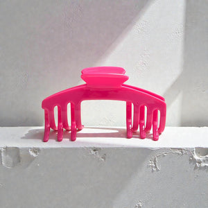 Flamingo hot pink hat claw clip displayed on a light surface, highlighting its bold color and everyday hat-friendly design.