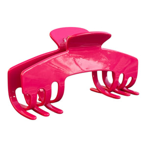 Angled view of the Fuchsia hot pink hat claw clip showing its curved shape and secure grip for thick hair.