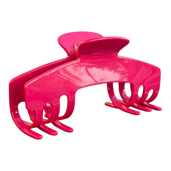 Angled view of the Fuchsia hot pink hat claw clip showing its curved shape and secure grip for thick hair.