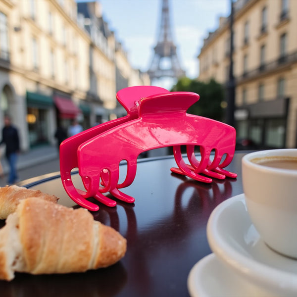 Fuchsia hot pink hat claw clip displayed at an outdoor cafe, designed for bold everyday hairstyles and comfortable wear with hats.