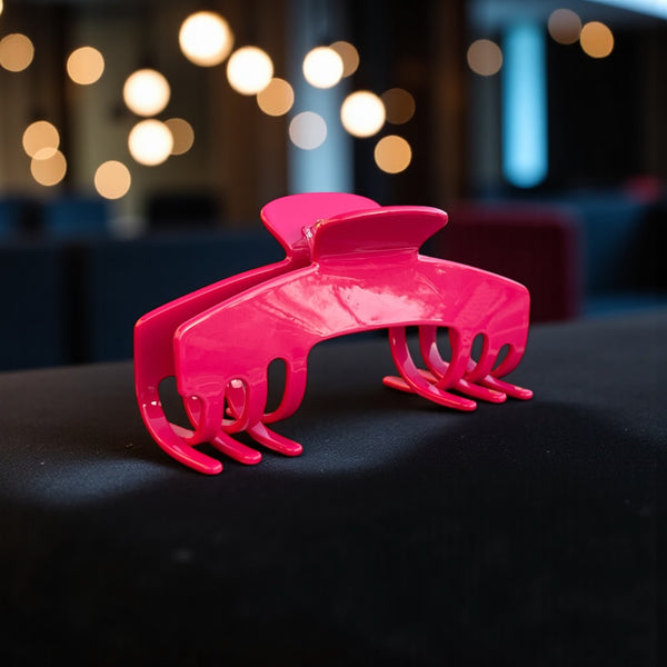 Fuchsia hot pink hat claw clip displayed in an evening setting, highlighting its bold color and everyday Power Hold design.