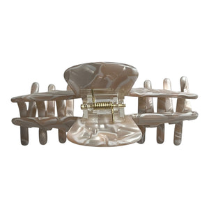 Back view of the Halo pearl beige hat claw clip showing the spring hinge and wide opening for a secure hold.