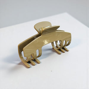 Haven taupe hat claw clip displayed on a clean surface, highlighting its neutral color and everyday Power Hold design.