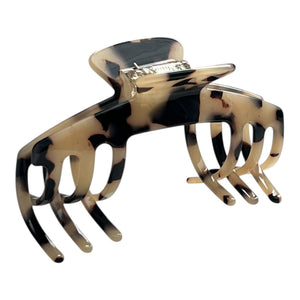Angled view of the Hazel tortoiseshell claw clip showing its curved shape and wide teeth for a secure hold.