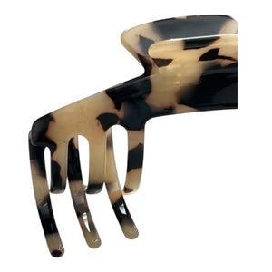 Close-up of the Hazel tortoiseshell claw clip highlighting its curved teeth, hinge, and black and tan pattern.