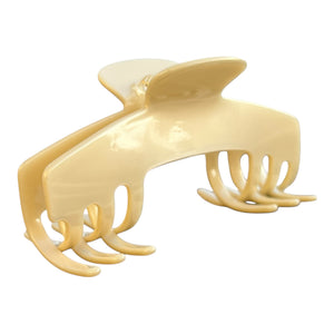 Angled view of the Ivory cream hat claw clip showing its curved shape, polished finish, and secure grip for thick hair.