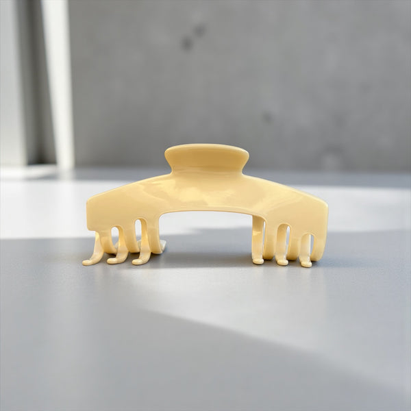Ivory cream hat claw clip displayed on a clean surface, highlighting its polished neutral finish and everyday Power Hold design.