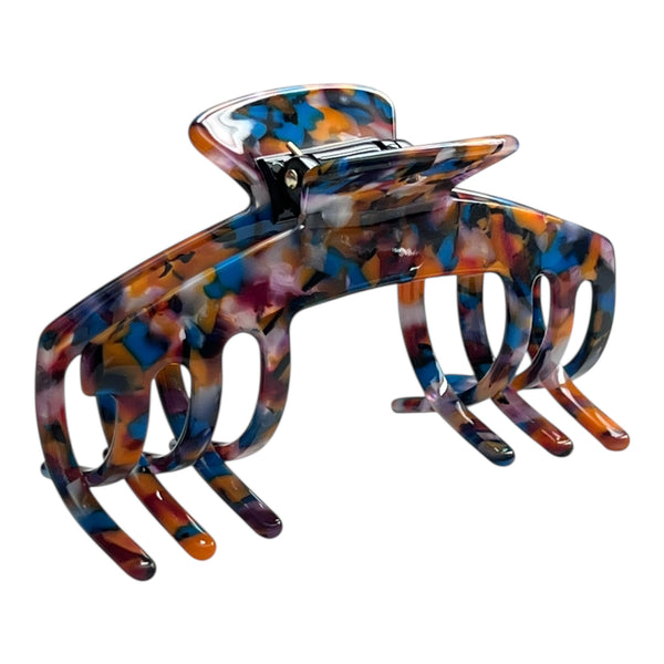 Angled view of the Mosaic tortoiseshell claw clip showing its curved shape and wide teeth.