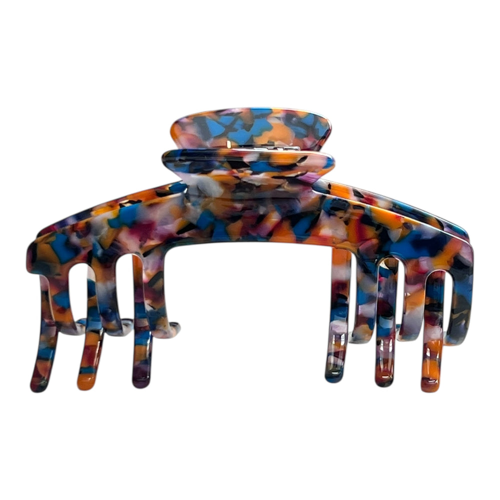 Front view of the Mosaic multicolor tortoiseshell claw clip for hats with blue, amber, brown, and black tones.