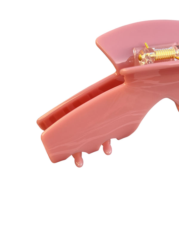 Close-up of the Muse pink hat claw clip highlighting the smooth finish and secure grip.
