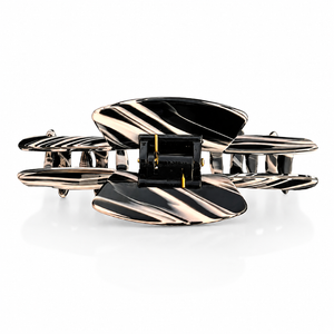 Top view of the Noir black and  view of the Noir black and white hat claw clip showing the spring hinge and wide opening for a secure hold.