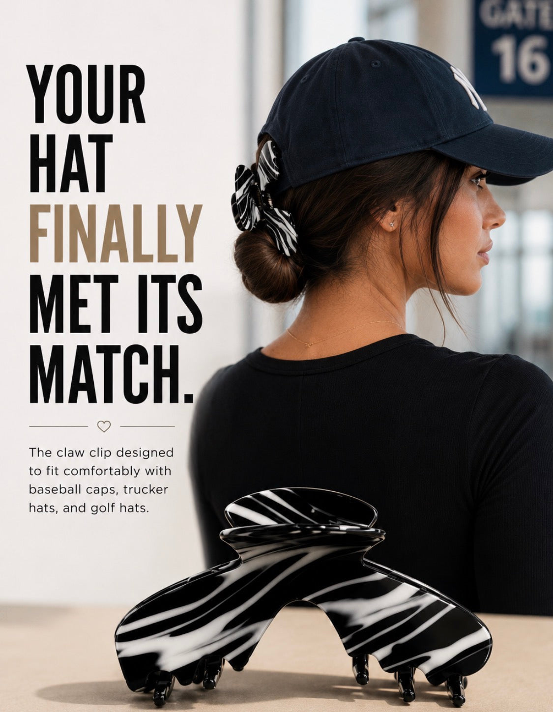 A woman shown from the back wearing a navy baseball cap with a black-and-white claw hat clip called Noir Hat Claw Clip  tucked behind her crown. The product shot also includes a large close-up of the Baddie claw clip in the foreground and promotional text on the left.