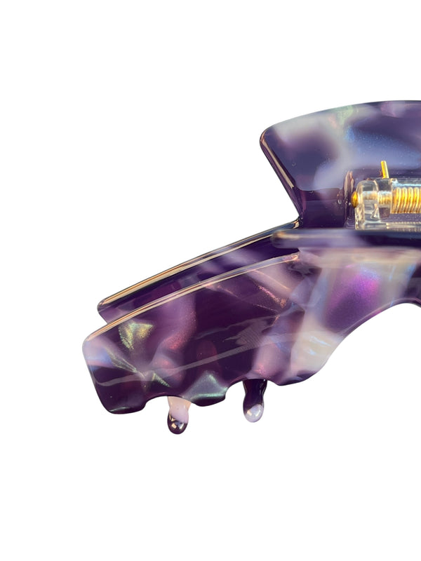Close-up of the Nova purple marble hat claw clip showing the glossy finish, spring hinge, and smooth grip teeth.