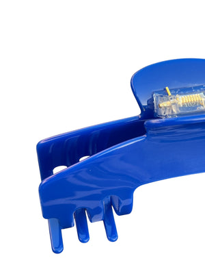Close-up of the Relentless cobalt blue hair claw clip showing the durable spring hinge and secure grip for thick, long, and textured hair.