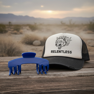 Relentless cobalt blue hair claw clip displayed beside a black and white trucker hat. Hair claw clip designed for hats to securely hold thick, long, and textured hair.