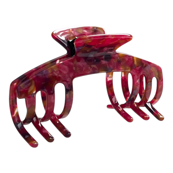 Angled view of the Ruby red mosaic hat claw clip showing its curved shape, bold pattern, and secure grip.
