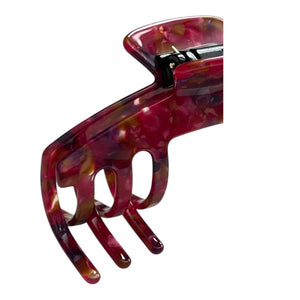Close-up of the Ruby red mosaic hat claw clip highlighting the glossy finish, curved teeth, and spring hinge.