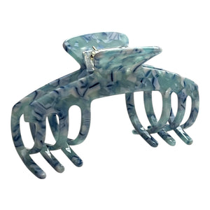 Angled view of the Sea Glass blue marble claw clip showing its curved shape and wide teeth.