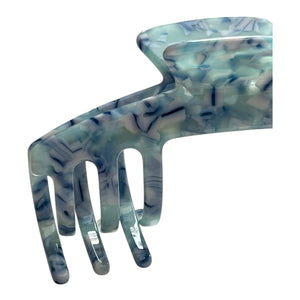 Close-up of the Sea Glass blue marble claw clip highlighting its marbled finish and curved teeth.