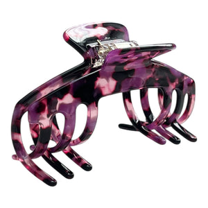 Angled view of the Velvet purple tortoiseshell hat claw clip showing its curved shape, bold pattern, and secure grip.