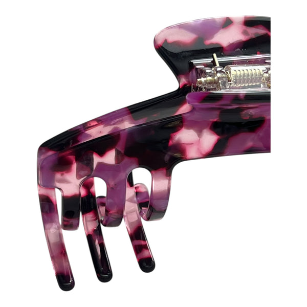 Close-up of the Velvet purple tortoiseshell hat claw clip highlighting the glossy finish, spring hinge, and curved grip teeth.